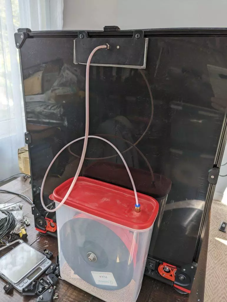 An airtight filament spool container connected to a Voron 2.4 3D printer