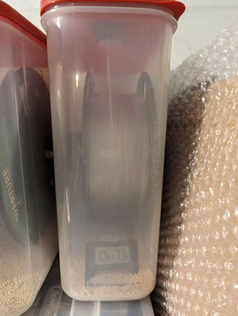 A PETG spool in an airtight filament container with molecular sieve bead reads 10% humidity