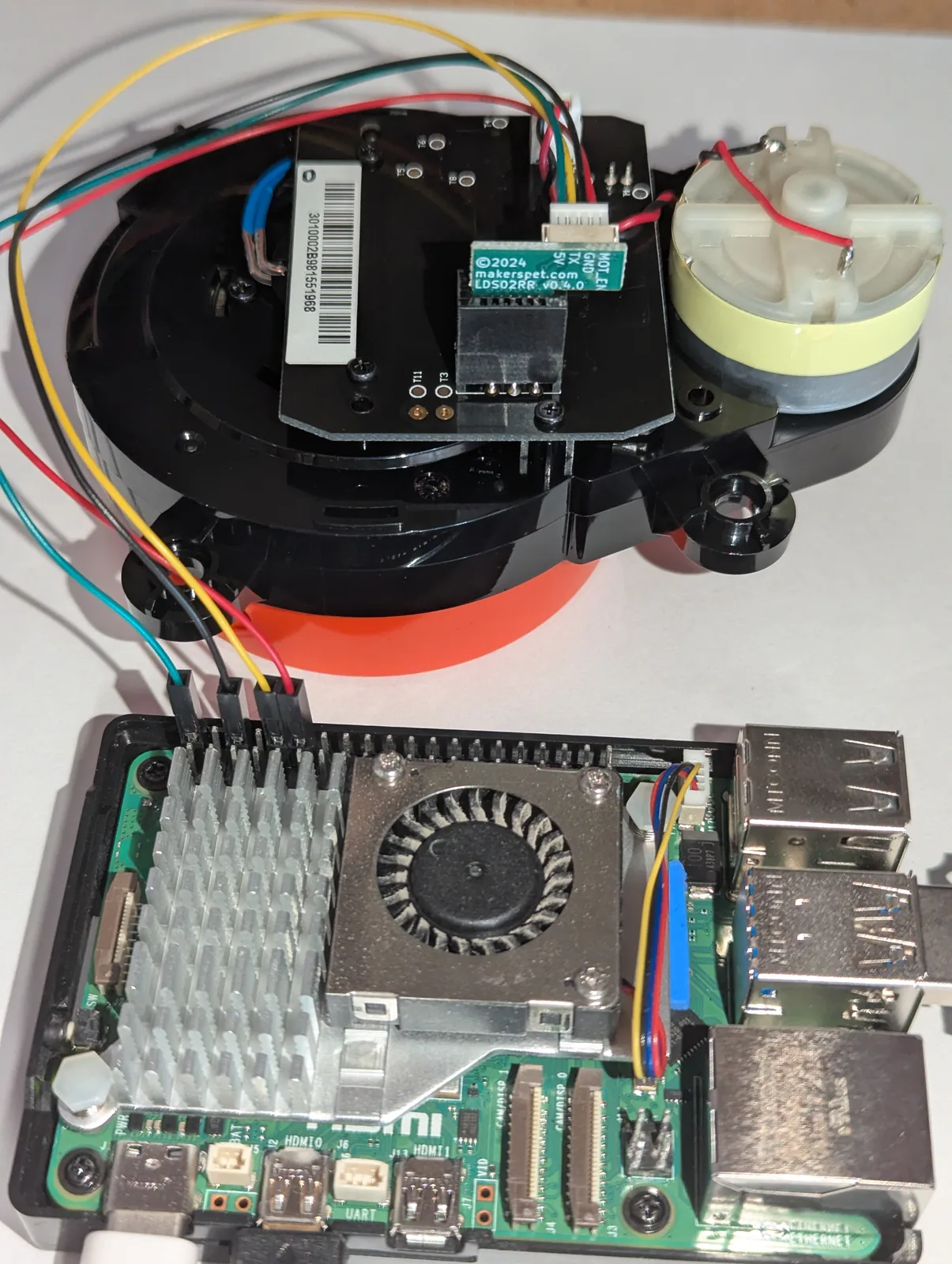 Maker's Pet LDS02RR adapter board mounted on the LiDAR, wired to a Raspberry Pi 5